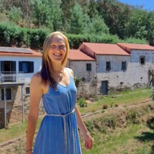 Maya Feliz rebuilding a corner of an old stone house during an off-grid homestead renovation