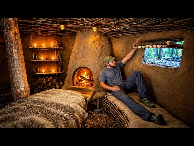 Building a warm log cabin shelter with clay stove in the forest for winter survival