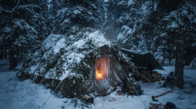 Insulated tent pitched in deep snow for extreme winter survival