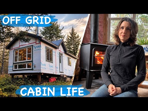 Stacked firewood and winter preparations at an off-grid cabin in the woods