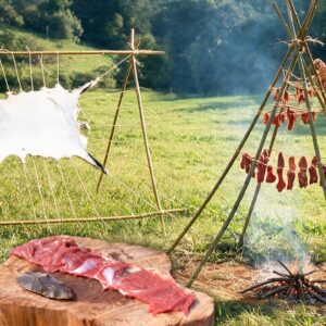 Documentary demonstration of primitive hide tanning and meat drying survival techniques using stone age tools