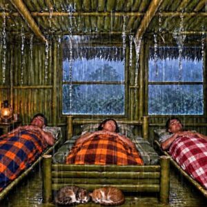 Bushcrafter building a lean-to shelter in the forest during heavy rain